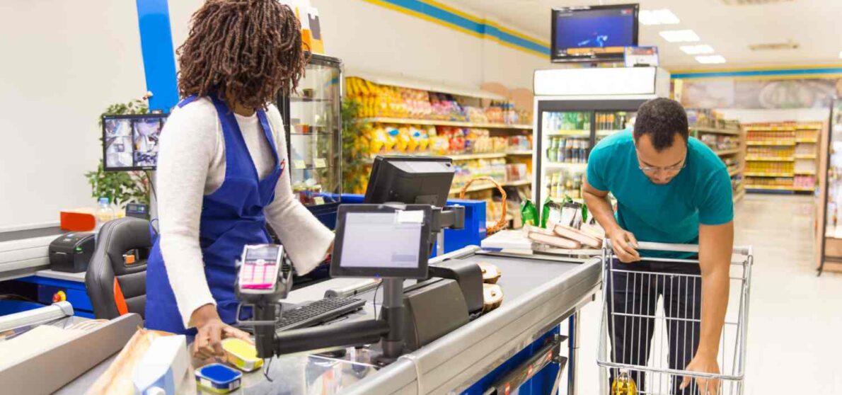 Convenience store owner helping customers
