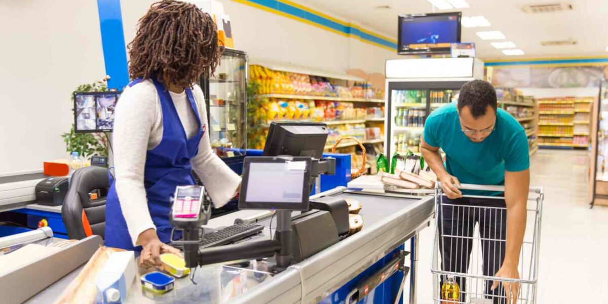 Convenience store owner helping customers